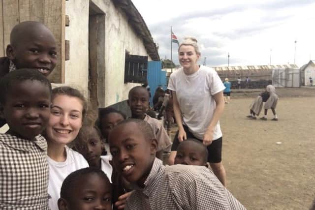 Taylor Allen with some of the children she met on her trip.