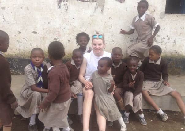 Taylor Allen with some of the children she met on her trip.