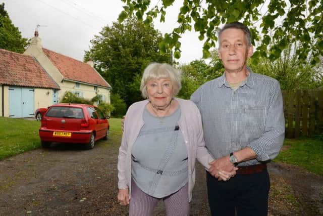 Thelma Peppert and John Proudlock outside Rose Cottage