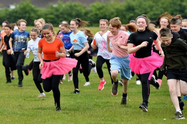 Pupils at Manor Community Academy taking part in their charity 5k run around the sports field for Cancer Research UK.
