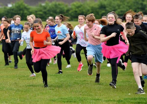 Pupils at Manor Community Academy taking part in their charity 5k run around the sports field for Cancer Research UK.