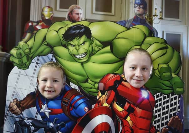 Seven-year-old Isabelle Coward(left) and twelve-year-old Lorie Dunn pictured with some of the comic heroes.